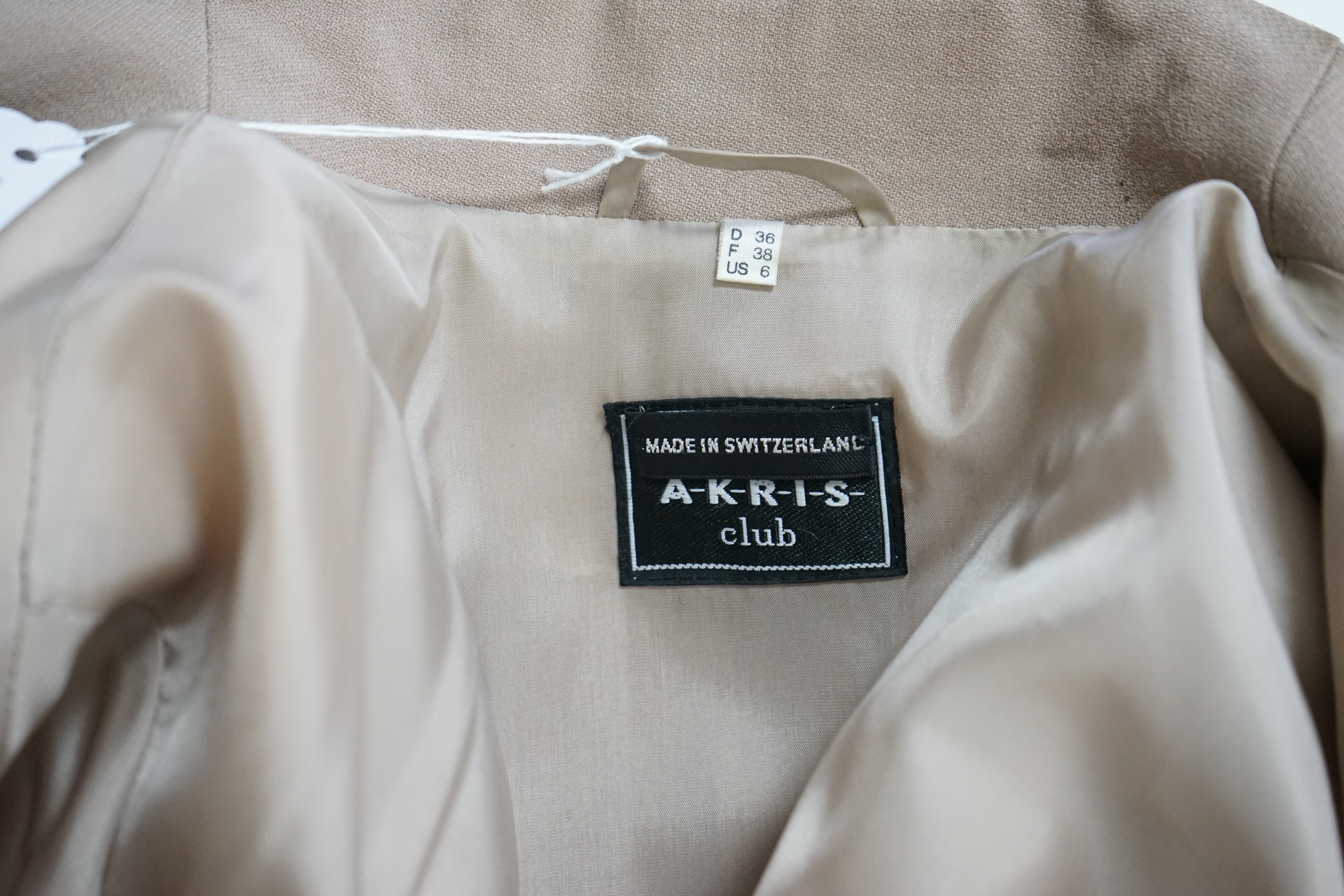 A lady's Akris Club suit with black turtle neck blouse and belt, UK Size 8. Proceeds to Happy Paws Puppy Rescue